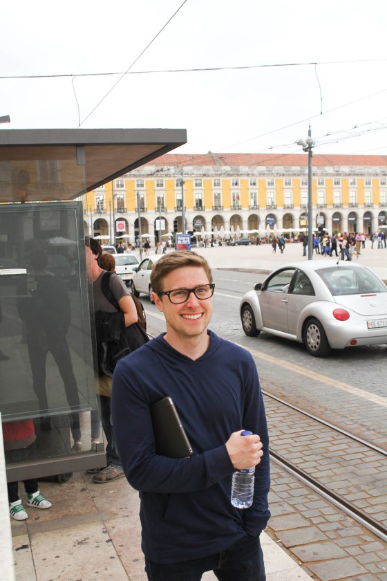 Alex waiting at the tram stop in the city center.